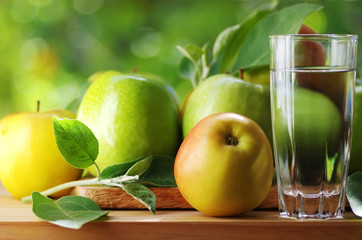 fresh ripe apples and glass of water