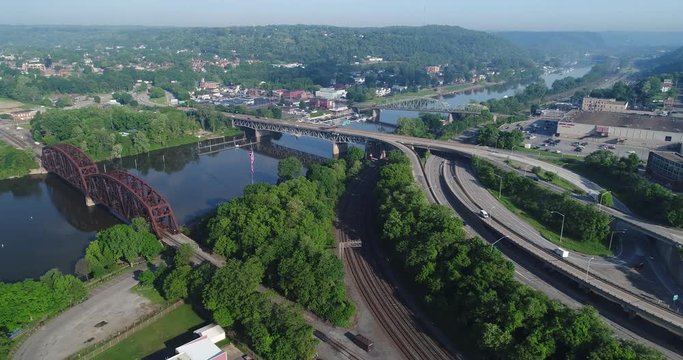 A slow aerial view of a small Pennsylvania town on the Ohio river. Pittsburgh suburbs.  	
