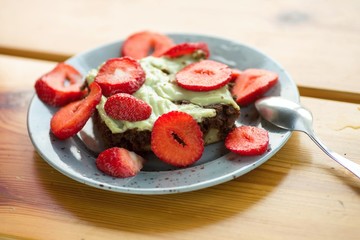 Chocolate cake with pistachio cream and fresh strawberry.