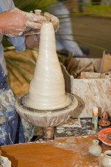 Hands man making ceramic pot working with clay on pottery wheel