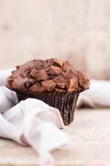 Homemade muffins with chocolate, vintage background.