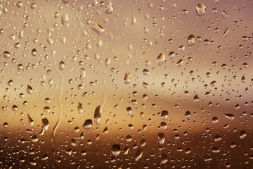 Drops of rain on blue glass background