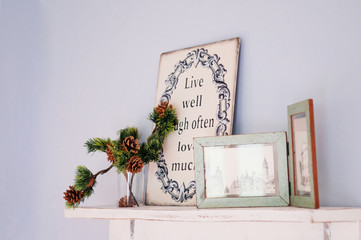 Wooden photo frame vintage home decorating and conifer pine cone on wooden shelf pastel color wall