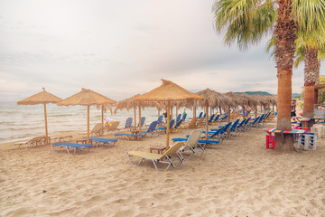 Alikanas, Zakynthos Island, Greece – September 28, 2017: Sunbeds, umbrellas and palms on the...