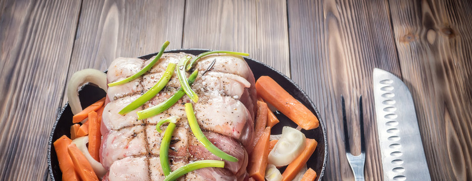 Raw pork chop marinated meat roll with assorted vegetables