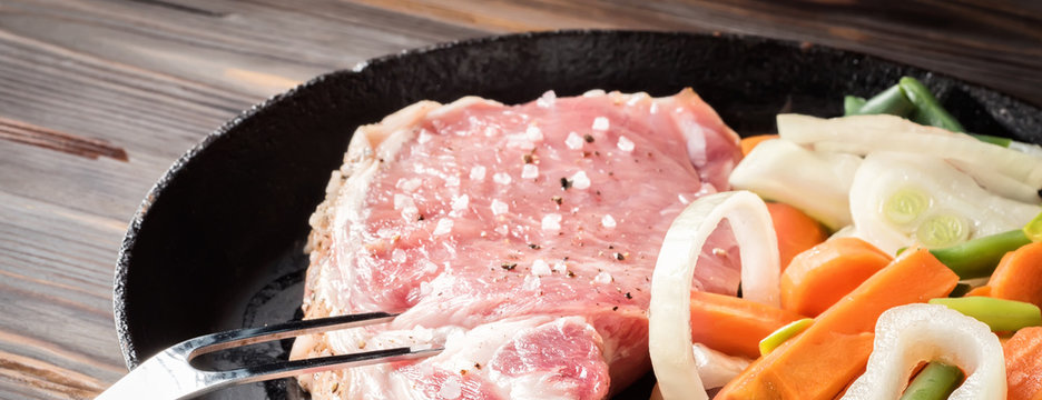 Raw pork chop marinated meat roll with assorted vegetables