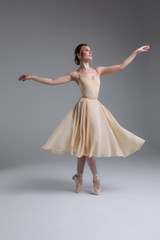 Dance is that delicacy of life! Full length side view portrait of the young attractive cheerful ballerina posing for the picture.