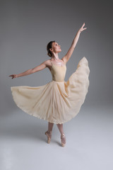 The blessing of a dancer! Full length picture of the young graceful charming smiling girl dancing in the modern ballet studio.