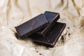 Pieces of chocolate tile on kraft paper