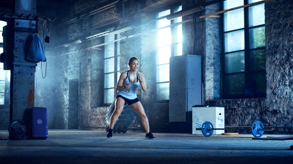 Fit Athletic Woman Does Footwork Running Drill in a Deserted Factory Remodeled into Gym. Cross...