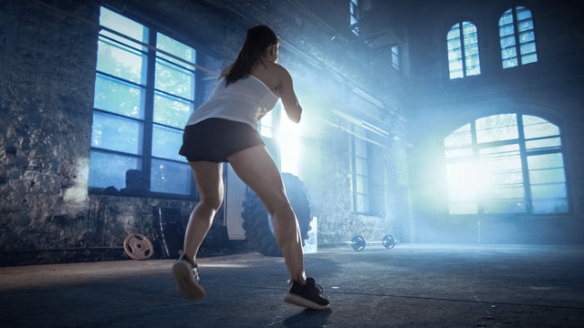 Fit Athletic Woman Does Footwork Running Drill in a Deserted Factory Remodeled into Gym. Cross Fitness Exercise/ Workout Aimed at Strengthening Legs, Enhancing Her Agility and Speed.