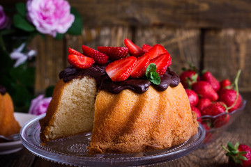 Bundt cake with chocolate ganache glaze and fresh strawberries