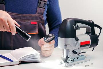 Professional technician working in repair service.Looking power-tool.
