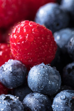  Ripe and juicy fresh blueberries and raspberries .