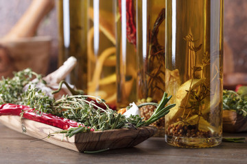 Bottles of olive oil with different spices and herbs.