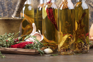 Bottles of olive oil with different spices and herbs.