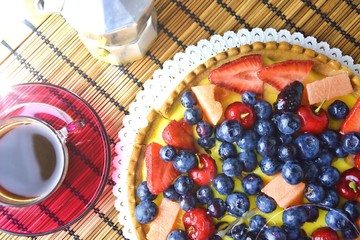 Crostata with berries and fruits and a cup of espresso