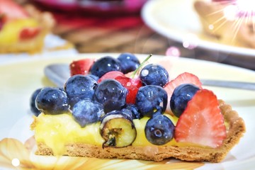 Piece of crostata with berries and fruits