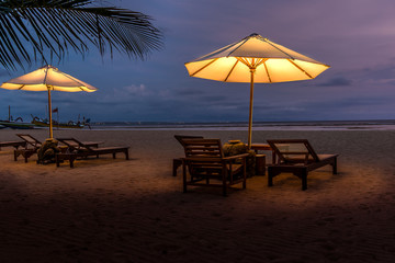 Umbrellas and sunbeds on the beach at night