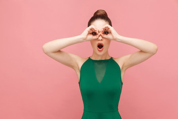 Binoculars sign. Woman looking far far away