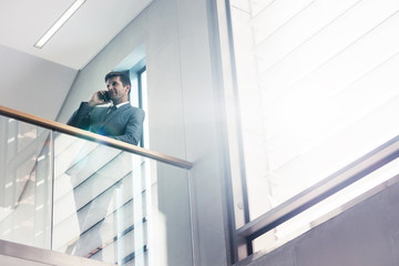 Businessman talking on mobile phone in office