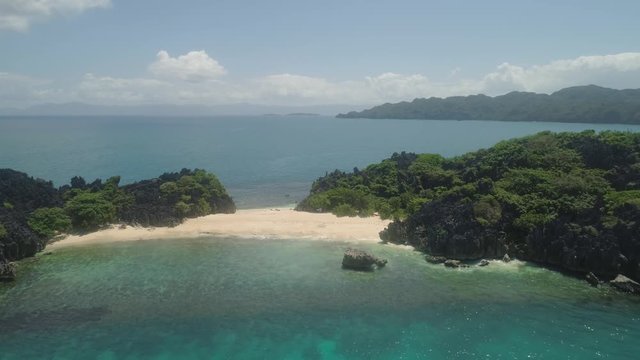 Aerial view islands with sand beach Lahus and turquoise water in blue lagoon among coral reefs, Caramoan Islands, Philippines. Landscape with sea, tropical beach.
