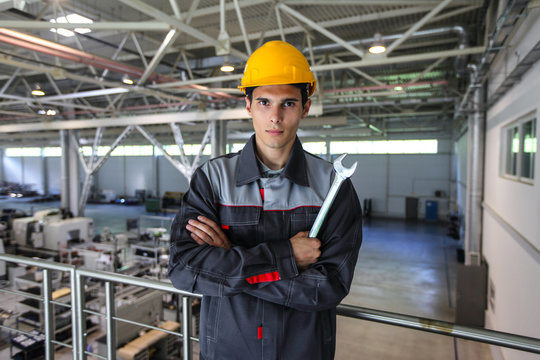 Worker with wrench at CNC factory