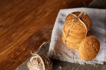 Pile of oat cookies on wooden table, close-up, selective focus.