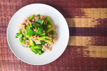 Stir fried kale with minced pork in white plate