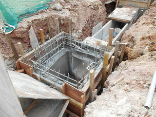 Underground drainage manhole under construction by construction workers at the construction site. The manhole design based on infrastructure engineer design.