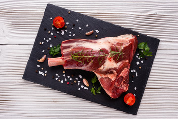 fresh lamb meat on a textured stone plate