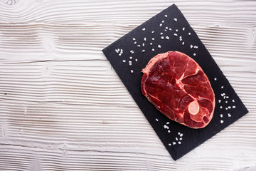 fresh lamb meat on a textured stone plate