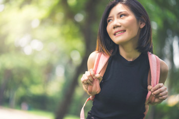 healthy asian woman relax and clam weekend vacation in green park  background