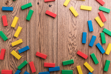 education and creativity ideas concept with colorful wooden brick block on brown wooden background