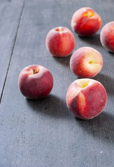 ripe homegrown peaches on black wooden table