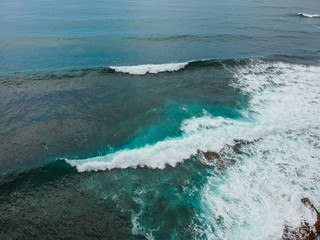 Aerial view from a surf spot with waves and a group of surfers in Ericeira, Portugal