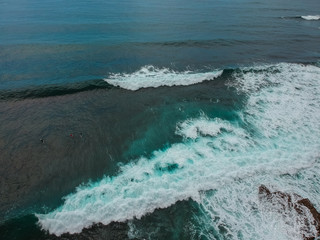 Aerial view from a surf spot with waves and a group of surfers in Ericeira, Portugal
