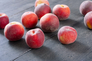 ripe homegrown peaches on black wooden table