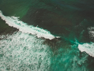 Aerial view from a surf spot with waves and a group of surfers in Ericeira, Portugal