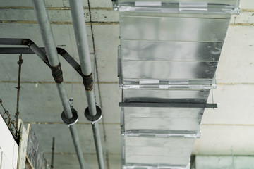 detial close up of air tunnel pipe work construction install on building concrete ceiling construction concept