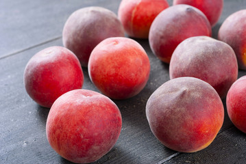 ripe homegrown peaches on black wooden table