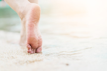 Beach travel concept. woman Legs on Tropical Sand Beach. Walking Female Feet Closeup