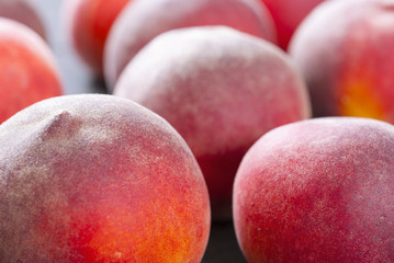ripe homegrown peaches on black wooden table
