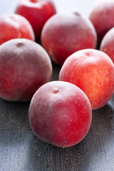 ripe homegrown peaches on black wooden table