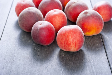 ripe homegrown peaches on black wooden table