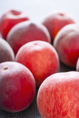 ripe homegrown peaches on black wooden table