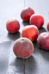ripe homegrown peaches on black wooden table