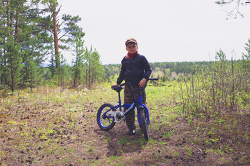 kid with bike outdoors