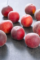ripe homegrown peaches on black wooden table