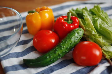 Fresh vegetables: tomatoes, green cucumber red Bulgarian pepper on the table